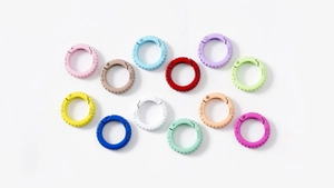 Flat lay of colorful alloy spring ring buckles for DIY keychains in 12 assorted matte colors