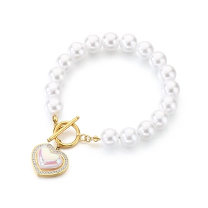 White beaded pearl bracelet with gold OT clasp and rhinestone heart charm on white background