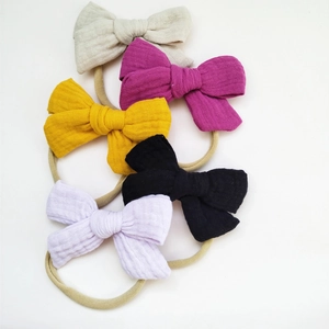 Five colorful muslin cotton baby headbands with large bows on soft nylon bands