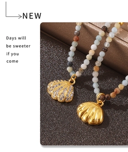 Detail of shell pendants with gold plating and white zircon inlay on colorful beaded necklace