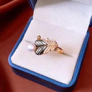 18k gold plated open ring featuring a pearl, shell leaf, and pavé crystal feathers