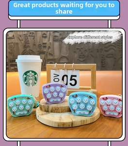Mini whack-a-mole game keychain in four colors on a wooden display stand for stress relief