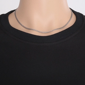 Macro shot of 45cm long and 3mm thick stainless steel curb chain necklace on a neck model