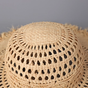 Detail of hand-woven raffia sun hat crown with intricate hollow diamond pattern