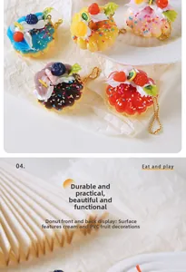 Macro detail of artificial fruit donuts with cream texture and gold metal keychain links