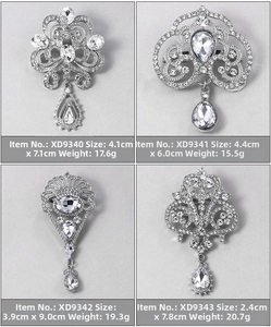 Detail view showing four vintage silver-tone brooches with crystals and size dimensions