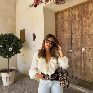 French style white V-neck chiffon blouse with ruffle edges and long sleeves on a model