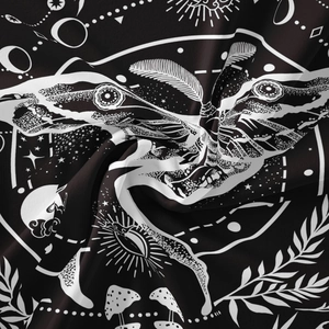 Detailed close-up of bohemian butterfly tapestry with celestial moon and star patterns