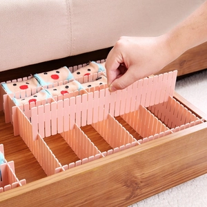 Pink adjustable plastic drawer dividers for organizing socks in wooden drawers