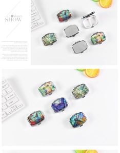 Macro view of portable metal pill box with 2 compartments and colorful nature patterns