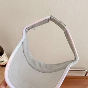 Close-up of lightweight quick-dry sun visor with pink trim and adjustable strap