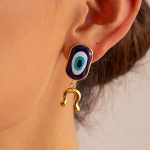 Evil Eye stainless steel earring with gold wavy pendant worn by a female model