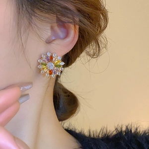 Detail of colorful zircon flower earrings on model with high quality gold plating