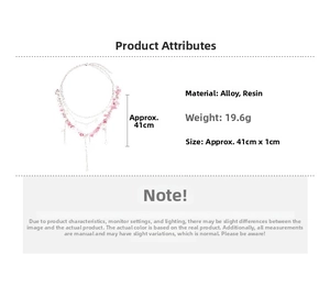 Detail of pink resin flower and bow on a multilayered alloy necklace for women