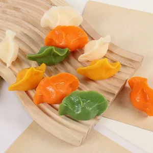 Set of colorful PVC artificial dumpling models displayed on a rustic wooden tray
