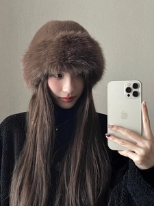 Detailed view of the thick brown faux fur bucket hat's fluffy texture and warm lining