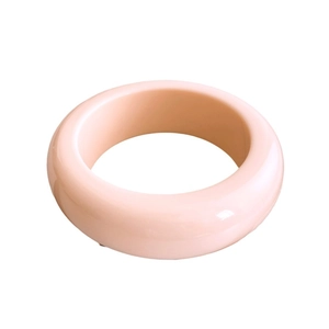 Polished light pink resin round bangle with irregular geometric cut in a 45-degree view