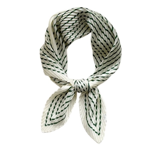 Green and white pleated silk scarf with geometric stripes in a knotted stylish display