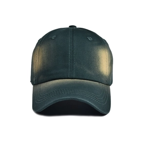 Front view of vintage tie-dye cotton baseball cap in dark green with yellow faded details