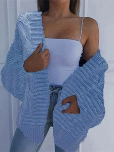 Close-up of light blue chunky cable knit mohair cardigan with textured stitch details