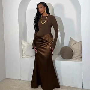 Detail of elegant dark brown evening dress with satin patchwork and pleated waist design