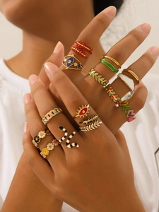 Detail shot of various 18k gold plated enamel rings with colorful patterns on model hands