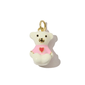 Detailed view of an enamel bear pendant with pink heart sweater and gold metal loop