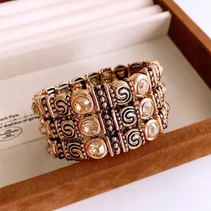 Vintage wide elastic gold bracelet with crystal rhinestone detailing and spiral textures
