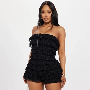 Close-up of black lace tiered tube jumpsuit showing delicate fabric texture and ruffles