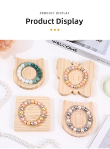 Macro view of beads on cat-shaped and butterfly wooden jewelry display trays