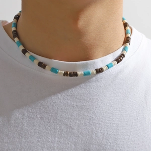 Close-up of bohemian beaded necklace with turquoise, brown wood, and white beads