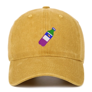 Detail of vintage washed yellow baseball cap showing fine bottle embroidery texture