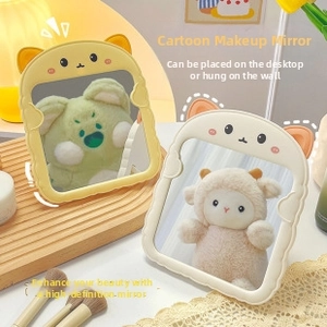 Detail of cartoon animal makeup mirror showing desktop stand and wall-mounted options