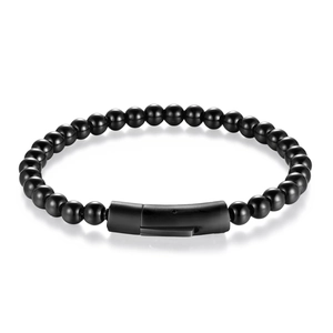 Macro view of polished black beaded bracelet with matte metal magnetic clasp