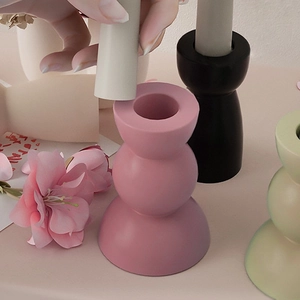 Minimalist matte geometric candle holder in pink, black and green with triple sphere design