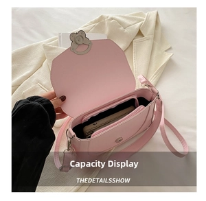Detailed internal view showing capacity of a pink shoulder bag with zipper pocket