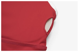 Detailed close-up of red yoga bra fabric with removable white pad and neat stitching