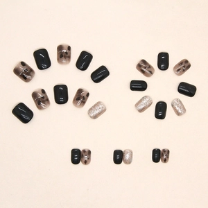 Black and amber press-on nails set with silver glitter and short square-oval shape