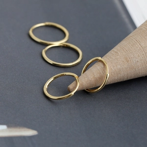 Detailed macro view showing the S925 hallmark on minimalist gold plated hoop earrings