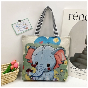 Detail of canvas tote bag with cartoon elephant print and striped handles