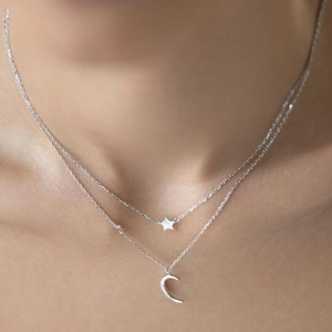Close-up of double-layer S925 silver necklace with sparkling moon and star pendants