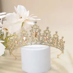 Detailed close-up of Baroque gold crown with sparkling rhinestones and amber gemstones