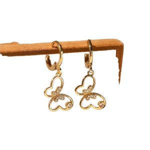 18K gold plated butterfly drop earrings with cubic zirconia on a brown display stand