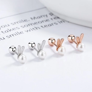 Detailed macro view of 925 silver rabbit ear stud earrings with pearls and screw back