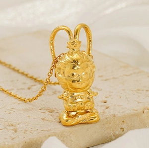 Detailed close-up of 18K gold-plated Wukong pendant with matte and polished finishes