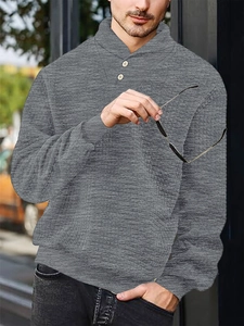 Detail of grey waffle knit polo collar with button fastening on men's long sleeve sweatshirt