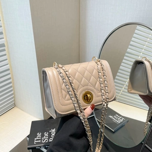 Elegant beige quilted crossbody bag with golden lock and chain strap hand-held view