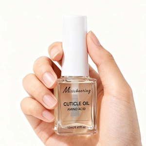 Close-up of hand holding 12ml amino acid cuticle oil for nourishing damaged nails