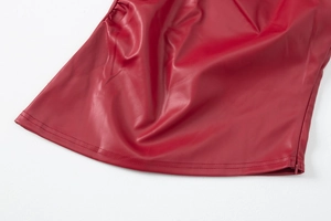 Detailed close-up of the double-stitched hem and zipper on a red PU leather vest