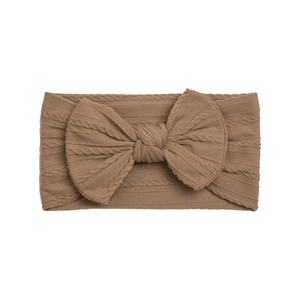Detailed cable knit texture and large bow on brown nylon infant headband
